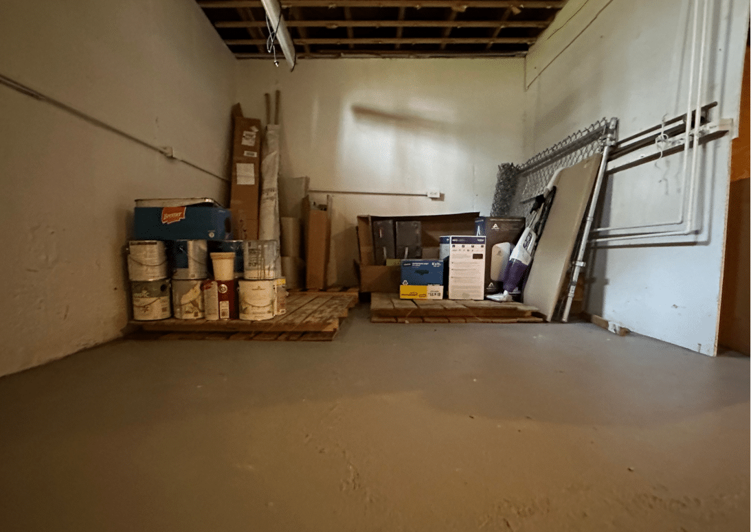 Clean and organized basement in Binghamton, New York, after Decluttering Chaos professional organizing services, with supplies neatly stacked and open space restored