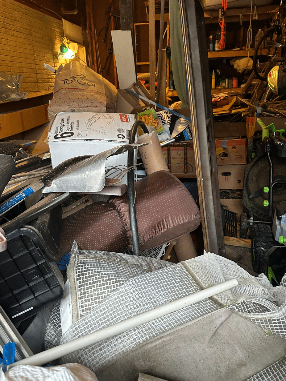 Cluttered garage space in Binghamton, NY before professional organizing services by Decluttering Chaos