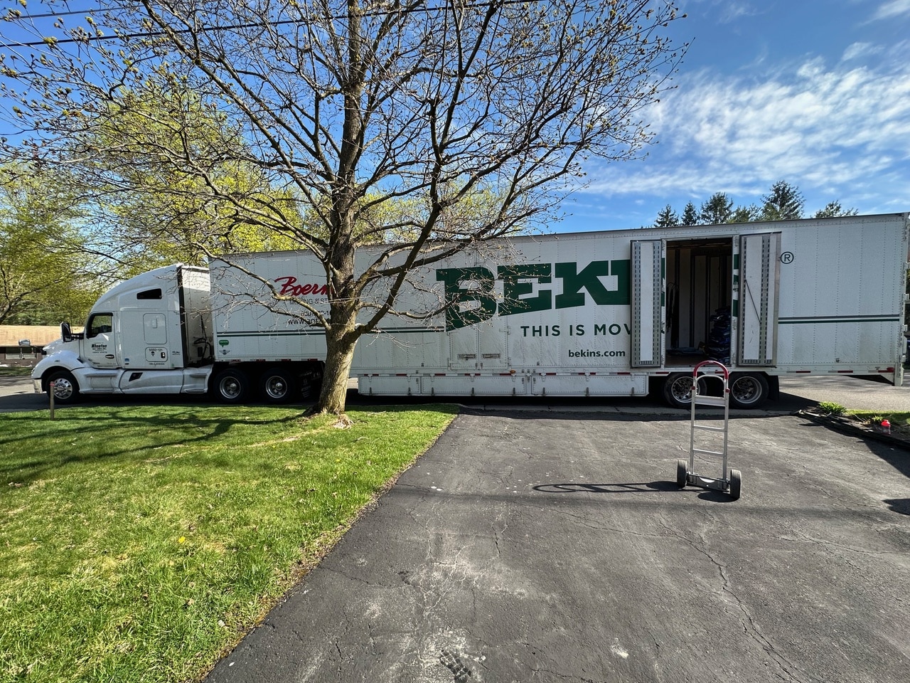 A Bekins moving truck parked in a residential driveway in Ithaca, New York, for a Decluttering Chaos moving and organizing project