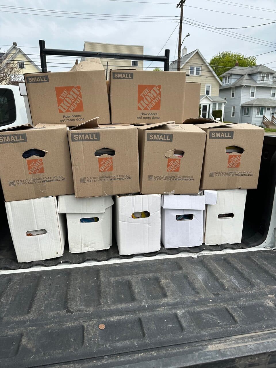 A neatly stacked load of moving boxes in the back of a truck in Ithaca, New York, prepared by Decluttering Chaos for an organized move or downsizing project
